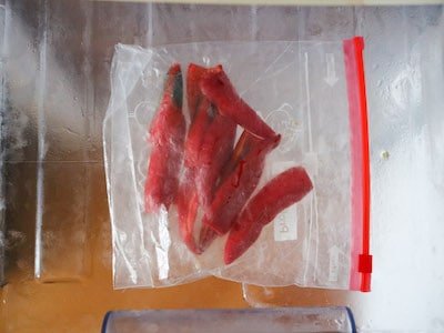 Red chillies sliced length ways in a freezer bag in the freezer