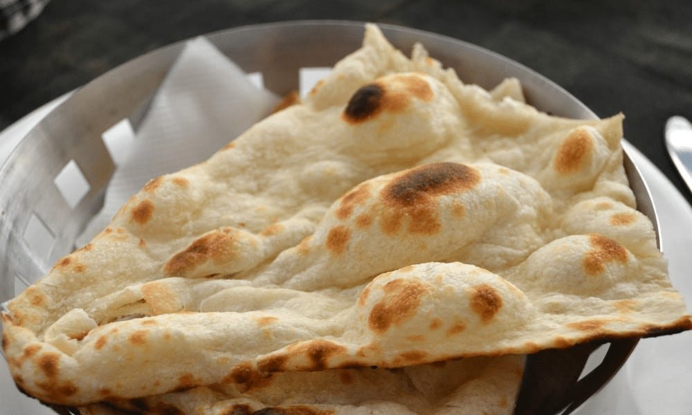 Close up of sliced naan bread in a bowl