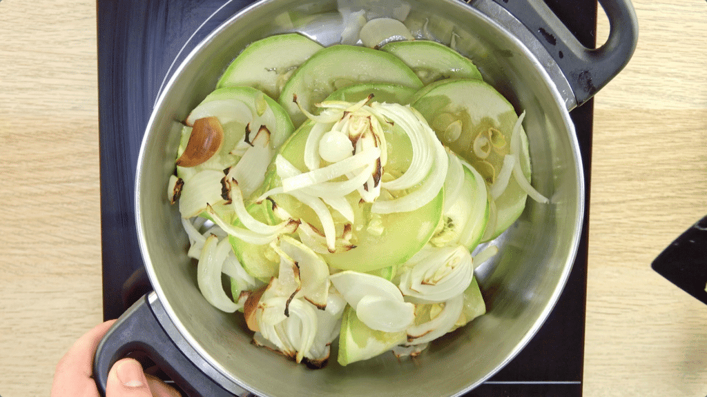 Roasted courgette, onion and garlic added a pot and placed on an electric hob