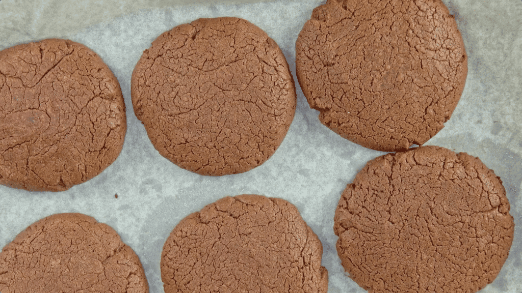 Baked Nutella cookies, 6 of them, on baking paper